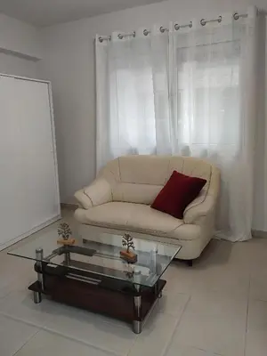 a living room with a couch and a coffee table at Alkinoos Studio in Nicosia