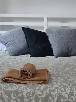 a towel sitting on top of a bed with pillows at Alkinoos Studio in Nicosia