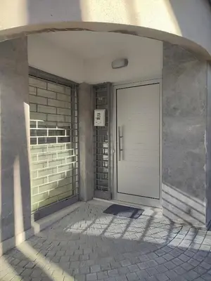 a white door on a building with a wall at Alkinoos Studio in Nicosia