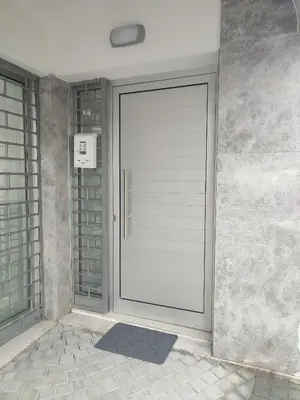 a glass door in a room with a brick wall at Alkinoos Studio in Nicosia