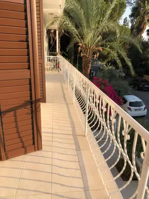 a white railing on a balcony with a palm tree at Bougainvillea in Nicosia