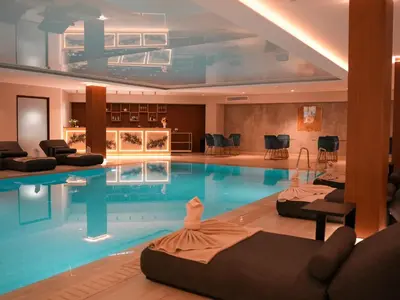a large swimming pool with chairs in a room at Aqua House Valentino in Limassol