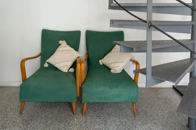 two green chairs with pillows in a room at ResArt Traditional House in Nicosia