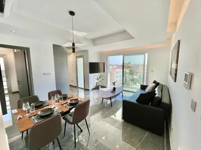a living room with a table and a couch at V-Premium Brand New Central flat in Limassol