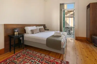 a bedroom with a bed and a table and a rug at Klokkari Stays - Cozy Stay City Center By Platform 357 in Nicosia