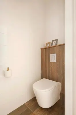 a white toilet in a bathroom with white tiles at Klokkari Stays - Cozy Stay City Center By Platform 357 in Nicosia
