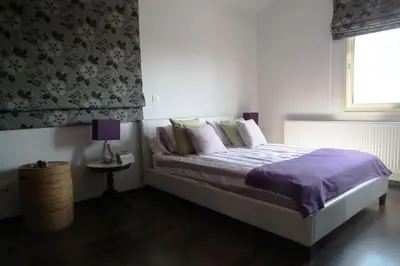 a bedroom with a bed with purple sheets and pillows at Villa Anthea-beach-private pool in Meneou