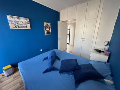 a blue bedroom with a bed with blue walls at It can't be more central Larnaca in Larnaka