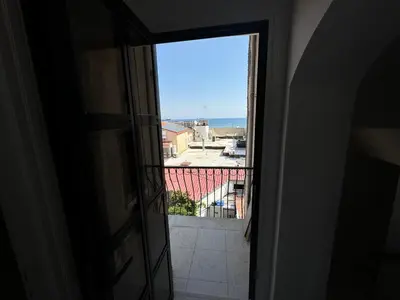 a view of the ocean from a window at It can't be more central Larnaca in Larnaka