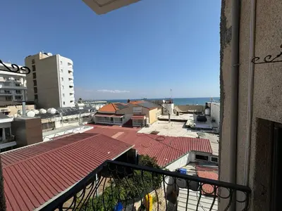 a view of the ocean from a balcony of a building at It can't be more central Larnaca in Larnaka