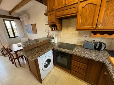 a kitchen with a washer and dryer in it at It can't be more central Larnaca in Larnaka