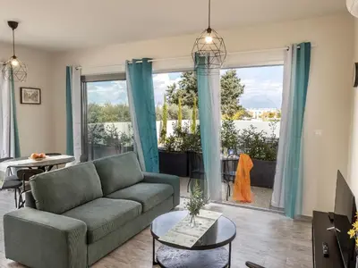 a living room with a couch and a large window at Mythical Blue Apartment 004 in Protaras