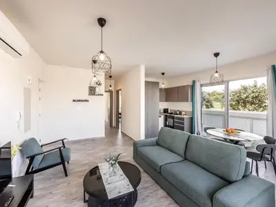 a living room with a couch and a table at Mythical Blue Apartment 004 in Protaras