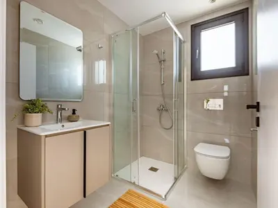 a bathroom with a shower and a toilet and a sink at Sanders Breeze Limassol in Limassol