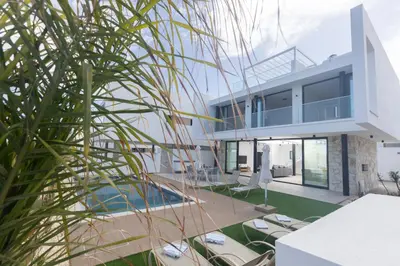 a house with a pool and a palm tree at Aqua Pearl Villas in Protaras