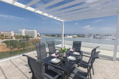a table and chairs on a balcony with a view at Aqua Pearl Villas in Protaras