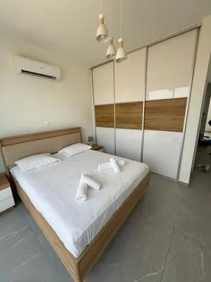 a bedroom with a large bed with white towels on it at Theo luxury Napa villa in Ayia Napa