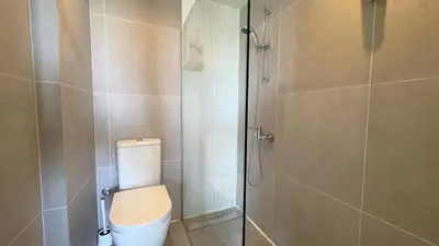 a bathroom with a toilet and a shower at Kolonaki Seaview 1BDR Finikoudes in Larnaka
