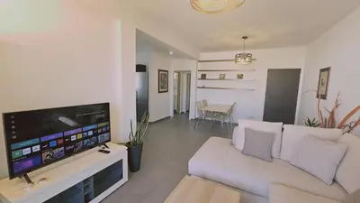 a living room with a couch and a flat screen tv at STAY Limdream Apartment in Limassol