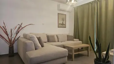 a living room with a couch and a table at STAY Limdream Apartment in Limassol