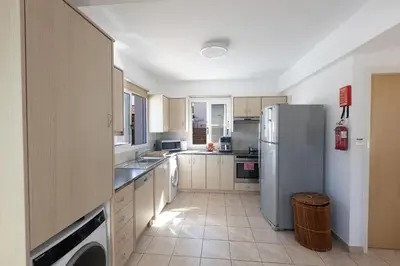 a kitchen with a refrigerator and a sink at Protaras Blue River Villa BR26 in Protaras