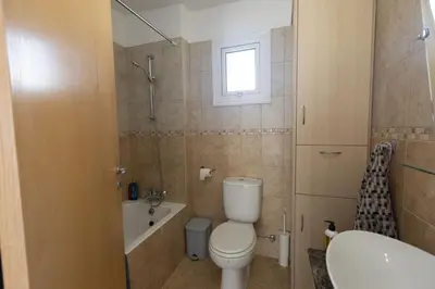a bathroom with a toilet and a sink at Protaras Blue River Villa BR26 in Protaras