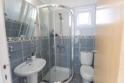 a bathroom with a shower and a toilet and a sink at Protaras Blue River Villa BR26 in Protaras