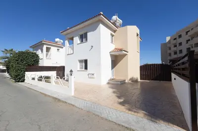 a white house with a gate and a street at Protaras Blue River Villa BR26 in Protaras