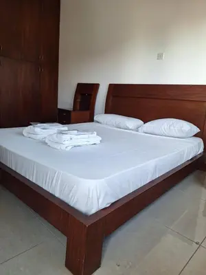 a bed with white sheets and white towels on it at D Pitsillos Homes in Larnaka