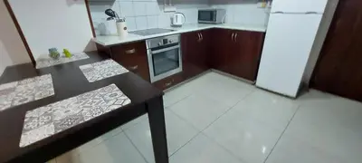 a small kitchen with a stove and a refrigerator at D Pitsillos Homes in Larnaka