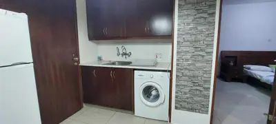 a kitchen with a washing machine and a sink at D Pitsillos Homes in Larnaka