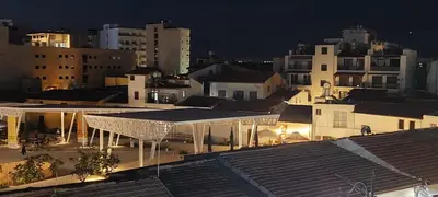 a view of a city at night with buildings at D Pitsillos Homes in Larnaka