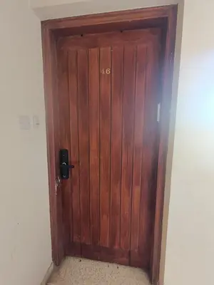 a wooden door in the corner of a room at Danit apartmnt by the sea in Zygi