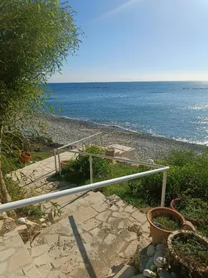 a staircase leading to a beach with the ocean at Danit apartmnt by the sea in Zygi
