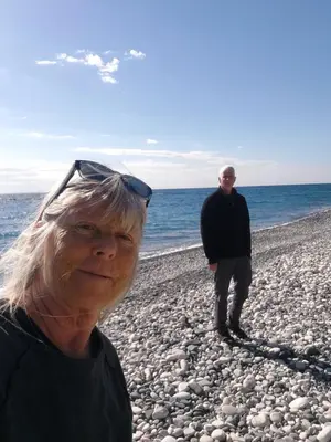 a man and an older woman standing on the beach at Danitsea villa with privat pool in Psematismenos