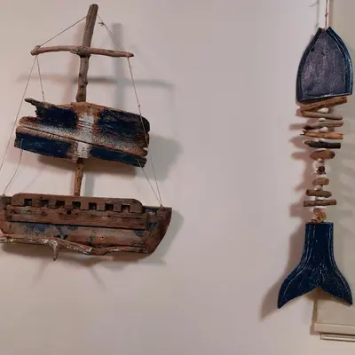 a wooden boat hanging on a wall at Danitsea villa with privat pool in Psematismenos