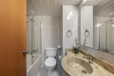 a bathroom with a sink and a toilet and a shower at Antigoni Hotel in Protaras
