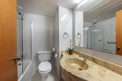 a bathroom with a sink and a toilet and a mirror at Antigoni Hotel in Protaras