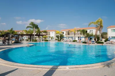 a large blue swimming pool in a resort at Tsokkos Paradise Holiday Village in Ayia Napa