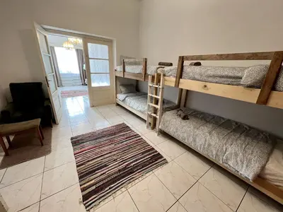 a room with two bunk beds and a rug at OLD Hostel in Limassol