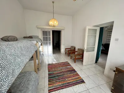 a room with two bunk beds and a living room at OLD Hostel in Limassol