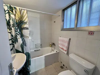 a bathroom with a toilet and a tub and a sink at OLD Hostel in Limassol