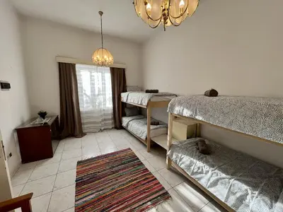 a bedroom with two bunk beds and a chandelier at OLD Hostel in Limassol