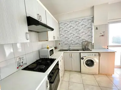 a kitchen with a stove and a washer and dryer at Central Comfort in Nicosia - Orfeos By Platform 357 in Nicosia
