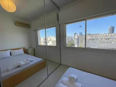 a bedroom with a glass shower and a bed with towels at Central Comfort in Nicosia - Orfeos By Platform 357 in Nicosia