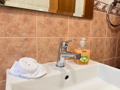 a bathroom sink with a faucet and a towel at Bungalow House Kiti, seaside in Kiti