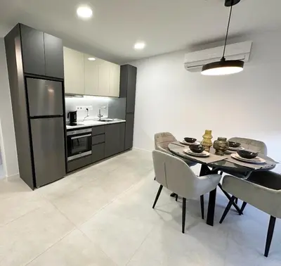 a kitchen and dining room with a table and chairs at Melia Suites in Limassol