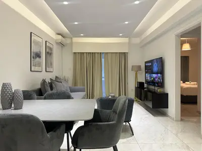 a living room with a couch and a table and chairs at Melia Suites in Limassol