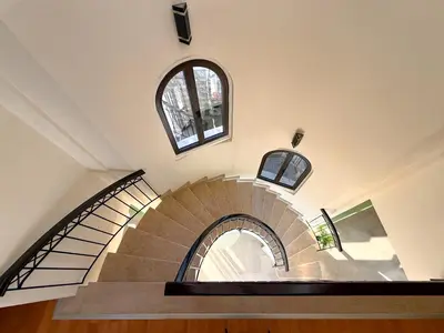 a spiral staircase in a building with two windows at Beachfront Villa with Private Pool and Exotic Fruit Garden in Pyla