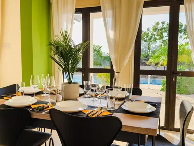 a dining room with a table and a large window at Beachfront Villa with Private Pool and Exotic Fruit Garden in Pyla